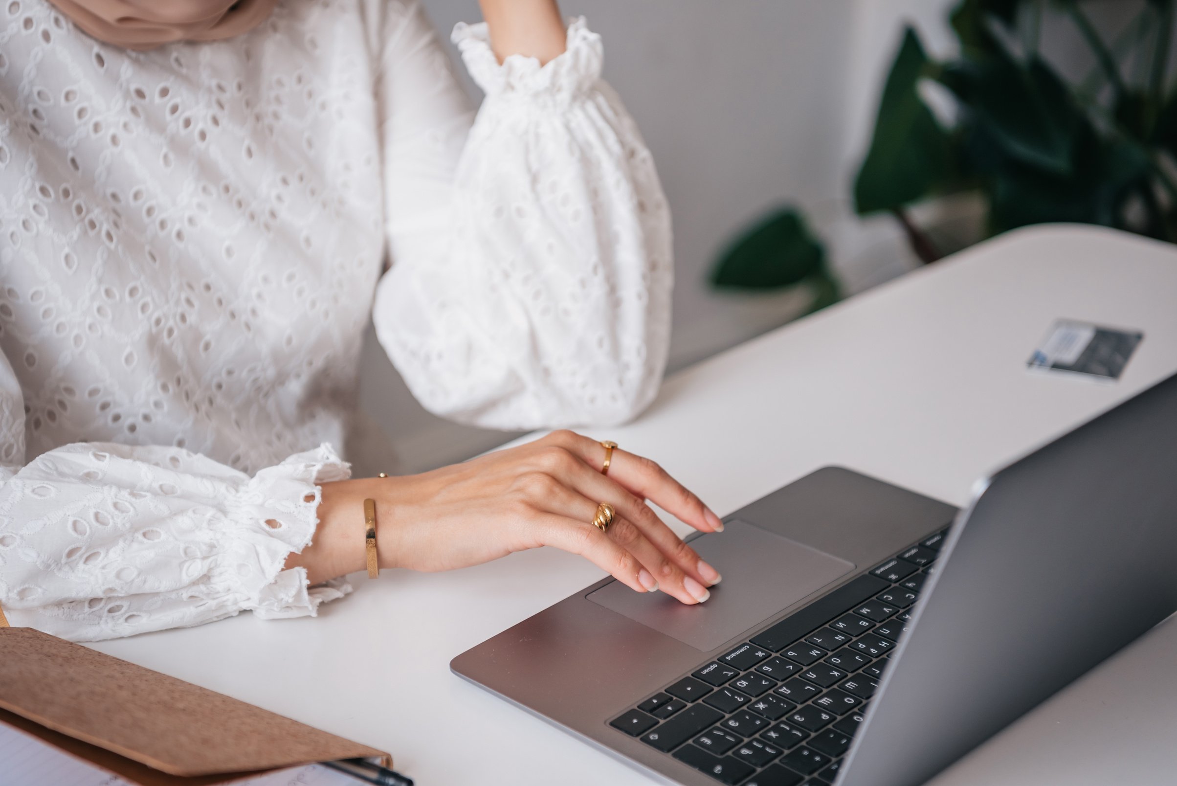 Woman in White Dress Using Black Laptop Computer